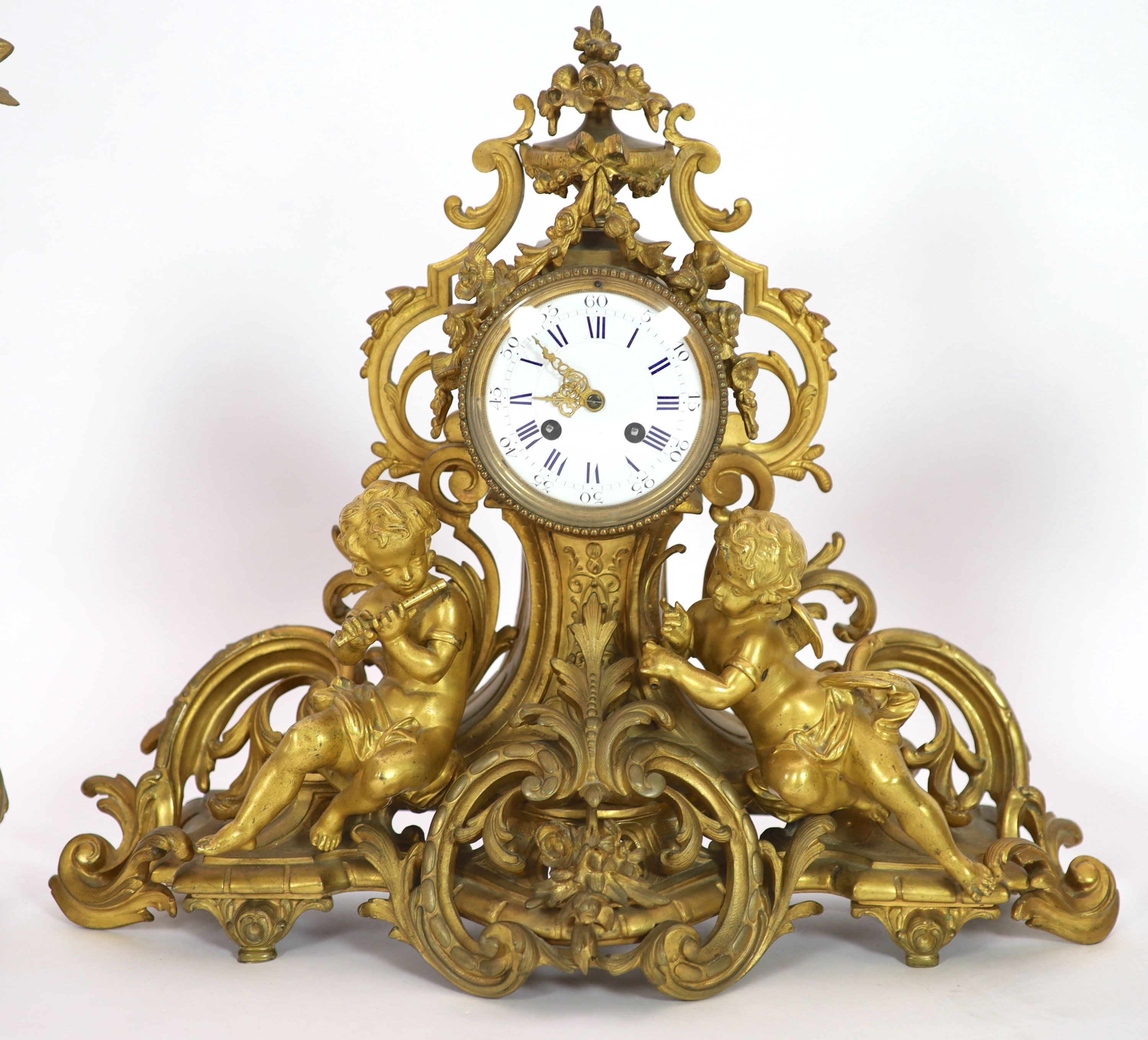 A 19th century Louis XV style ormolu clock garniture, clock H 43cm candelabra H 52cm